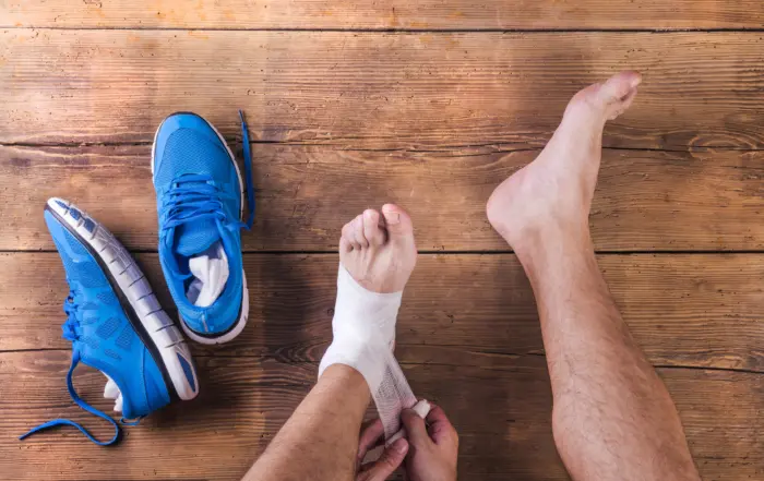 A man wraps his injured ankle