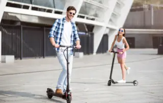 a couple rides scooters together