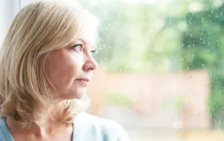 a woman looks out the window