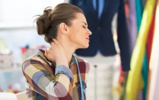 Woman holding her neck in pain