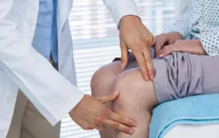 Doctor examining a patient's knee