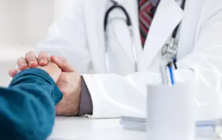 Doctor holding a patient's hand