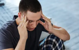 Male holding temples in pain