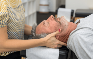 man laying on his back about to get a chiropractic adjustment