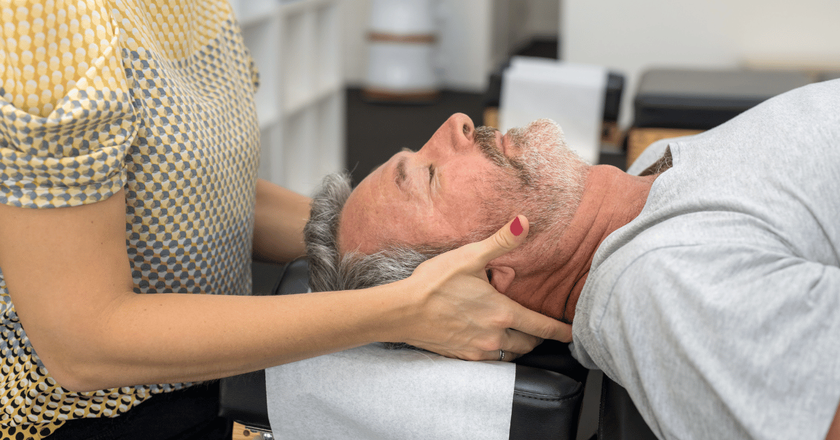 man laying on his back about to get a chiropractic adjustment