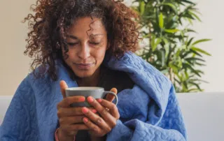 woman holding bug wrapped in blanket