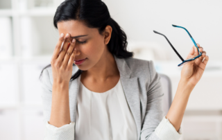 woman holding between nose suffering from a headache