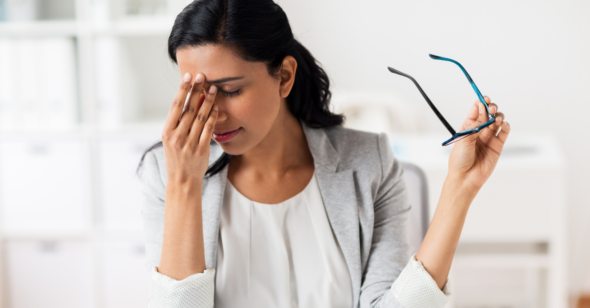 woman holding between nose suffering from a headache