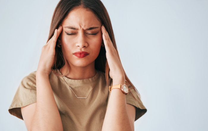 woman with hands on head with hormone imbalance