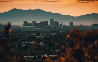 Phoenix Arizona at sunset with city and mountains in distance
