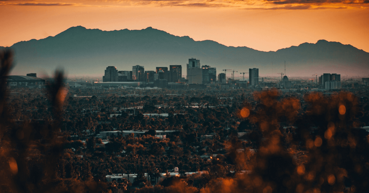 Phoenix Arizona at sunset with city and mountains in distance