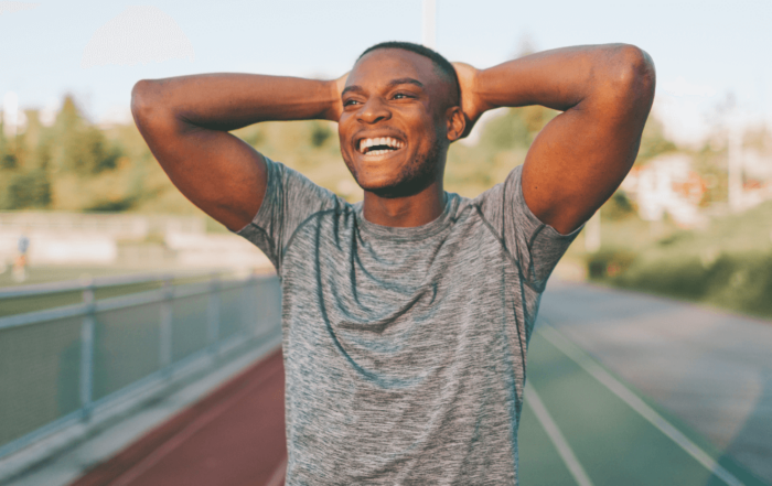 man smiling on running track