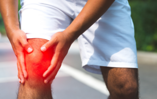 man holding painful knee