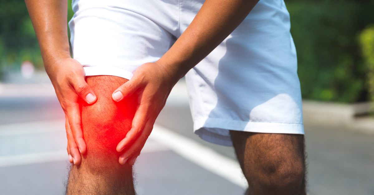 man holding painful knee