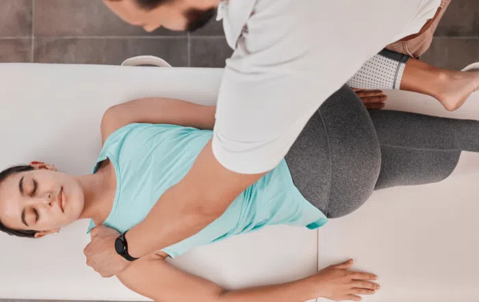 woman getting stretched by chiropractor to help with pain