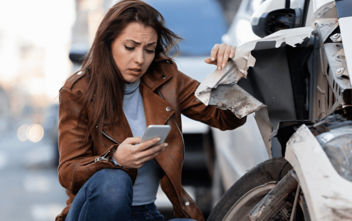 woman next to a car that has been in a car accident