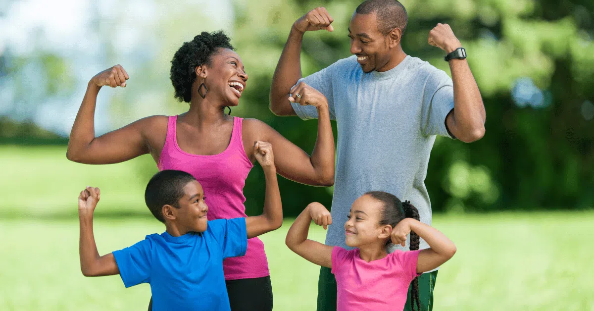 family flexing muscles and smiling