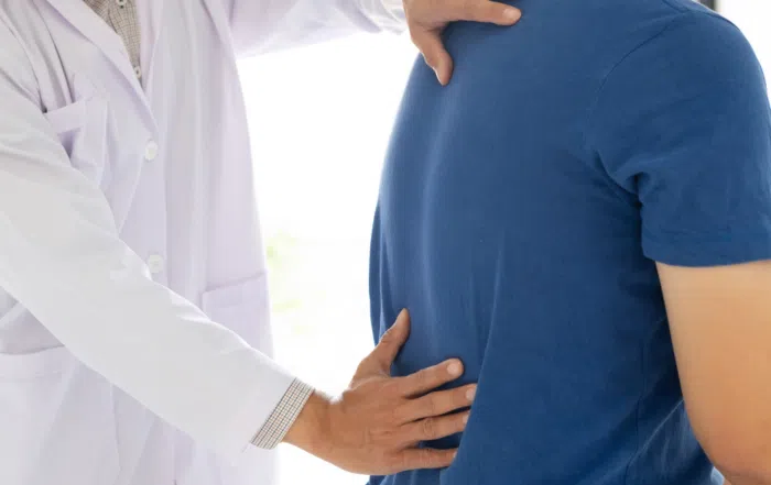 doctor examining a persons back