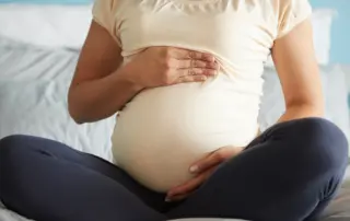 Pregnant woman holding her stomach