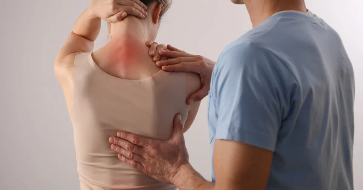 person with upper back pain getting medical exam